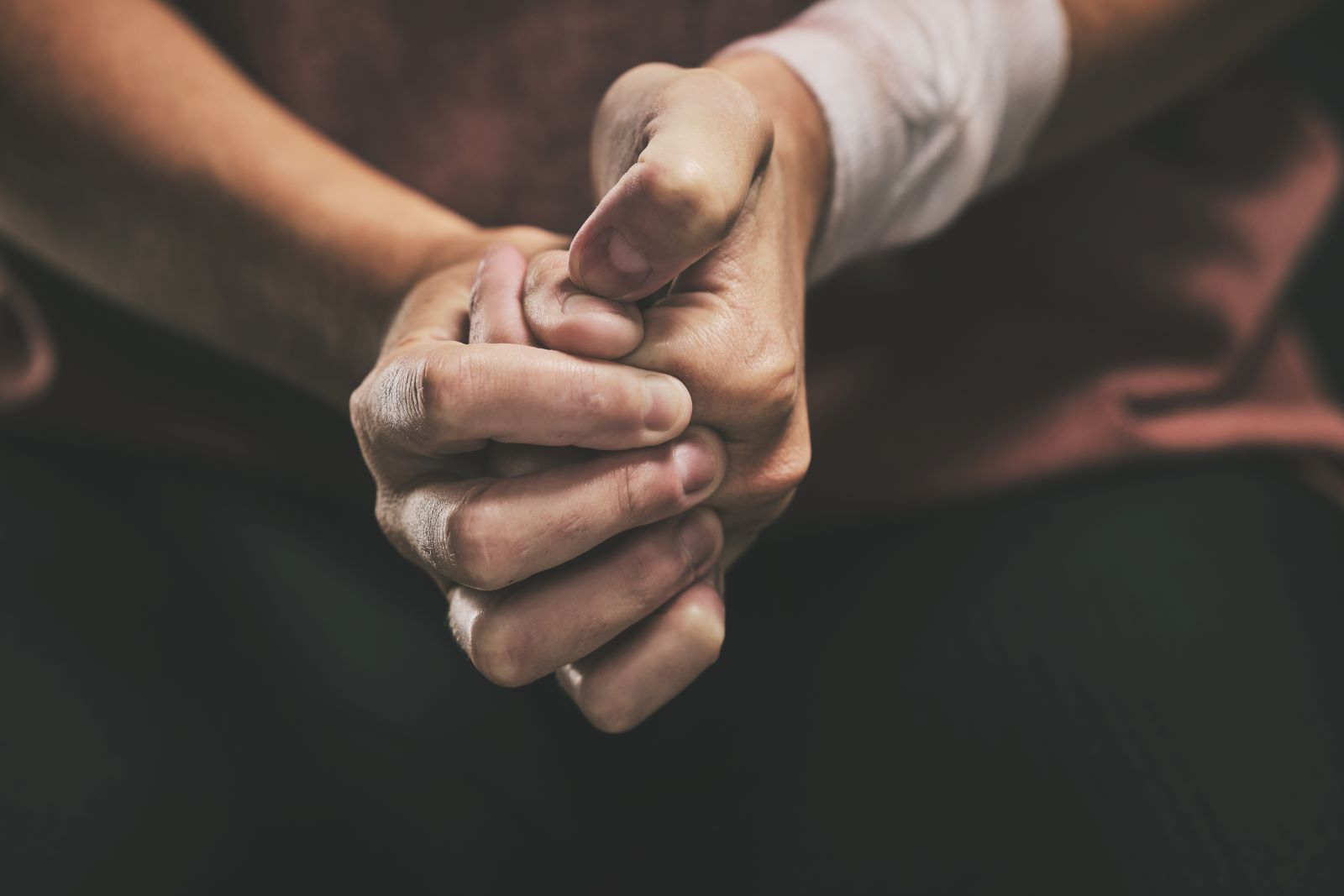 Anxious hands gripping.